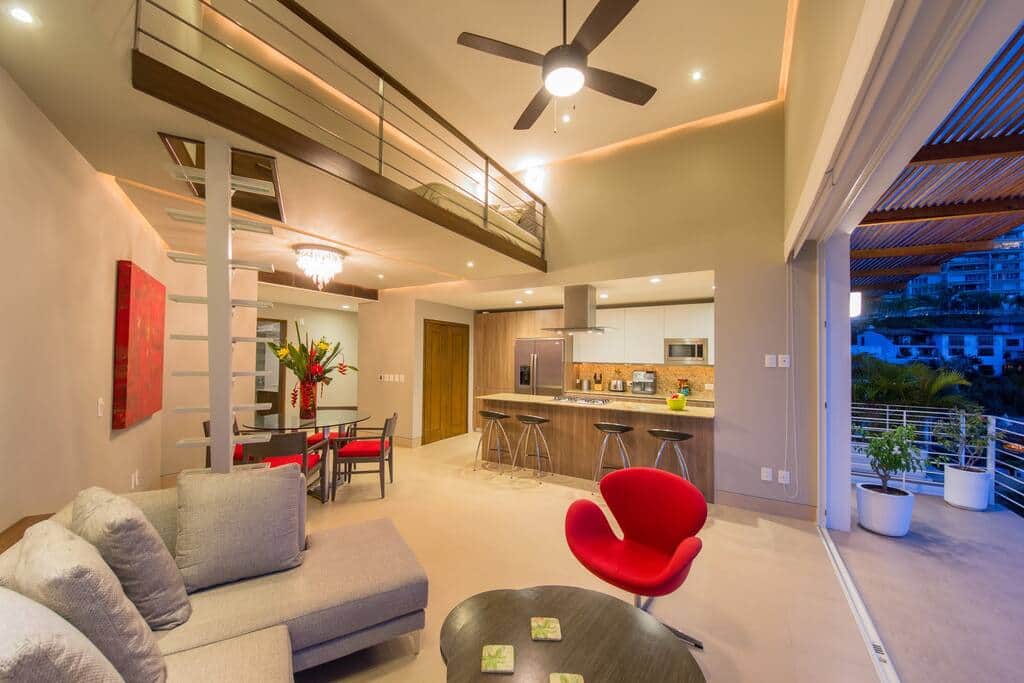 Living room with a glass staircase to the small loft.