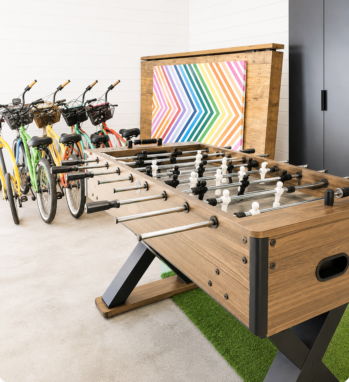 5 Cruiser Bikes and a Foosball table inside the garage game lounge at White Magnolia Galveston