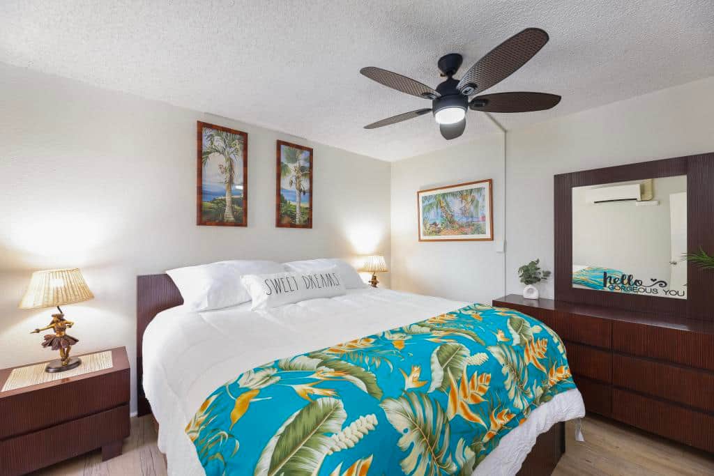 Plush bedding and extra pillows in bedroom closet with large dresser for your use.