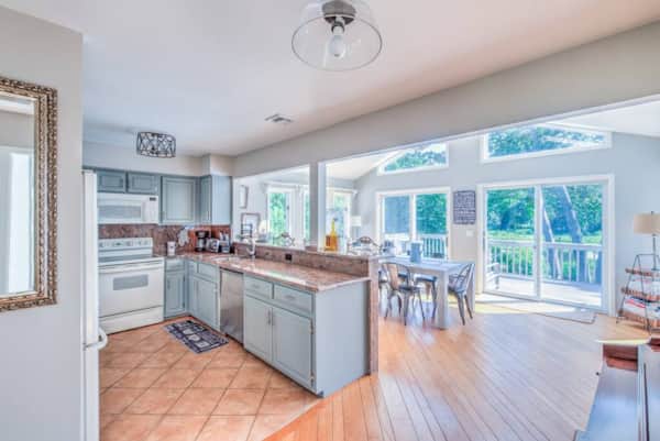 Upstairs kitchen with a breakfast bar opening to the dining room