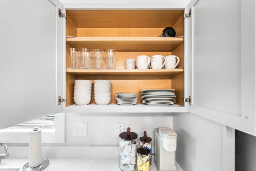 Fully stocked w/ cups, plates, coffee mugs