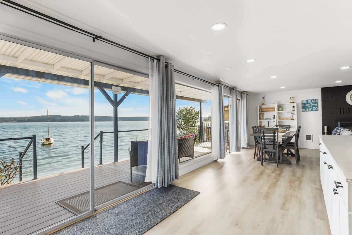 The living room has a wall of windows and large sliders that lead out to the deck. This creates an amazing view indoors with so much natural light. 
