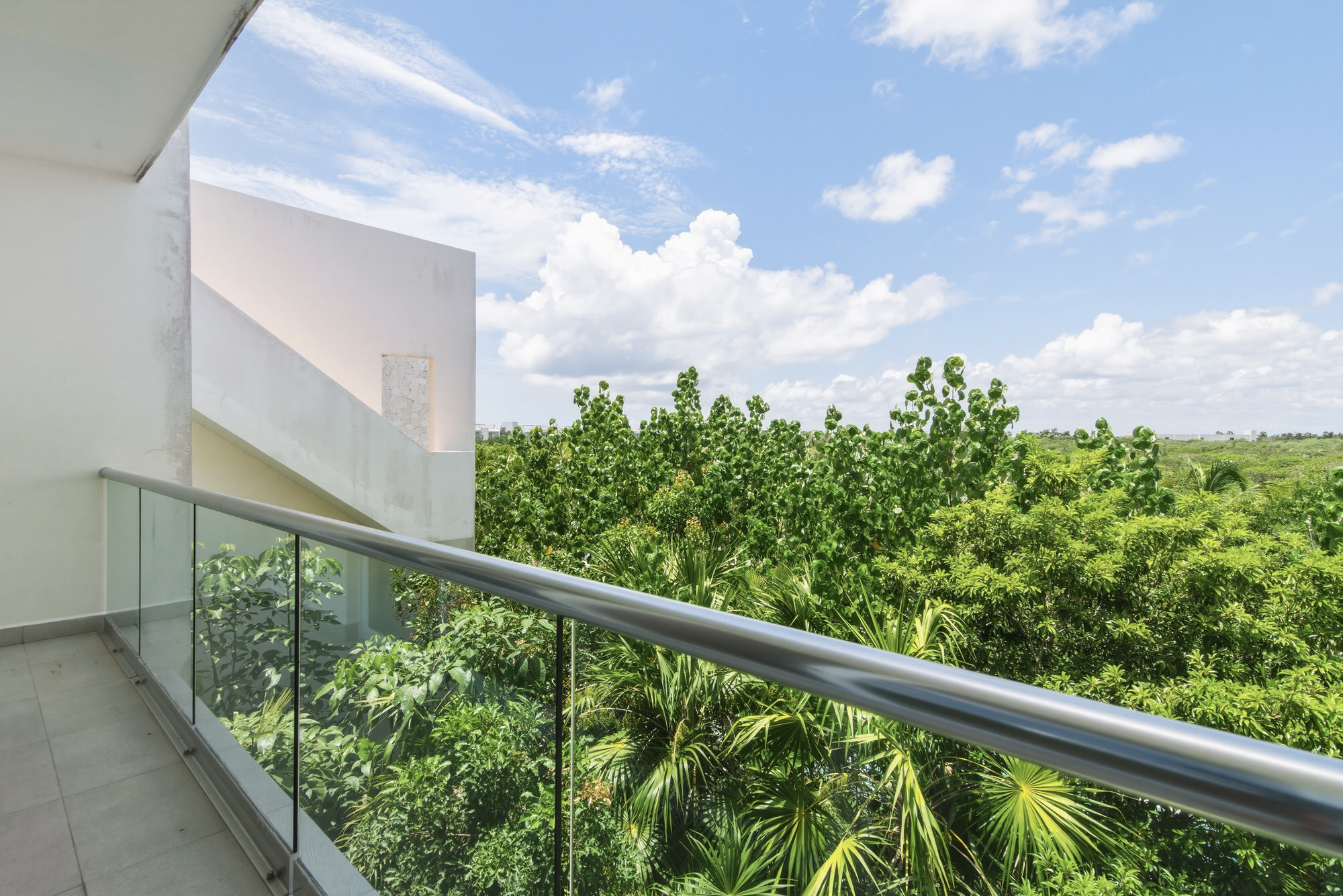 Both bedrooms open to a private balcony with fresh Caribbean breezes and lush Akumal jungle views.