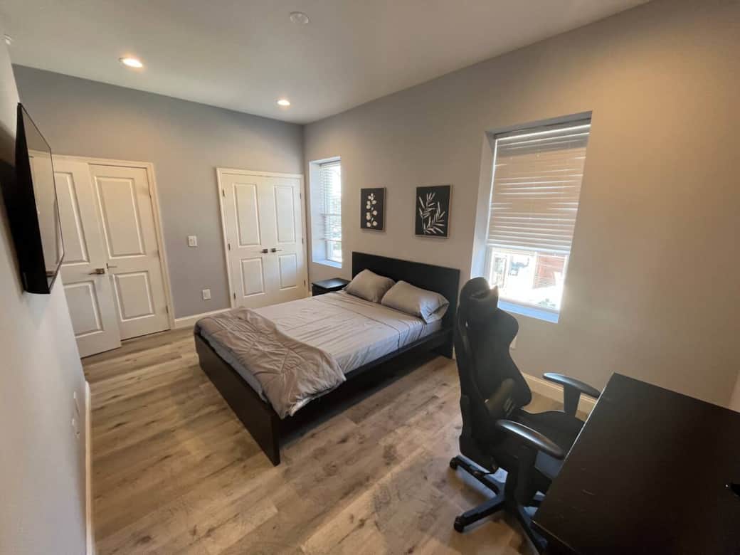 This comfortable bedroom includes a queen bed, flat-screen TV, darkening curtains, a side table, USB charging, lamp, and a spacious closet for all your storage needs.