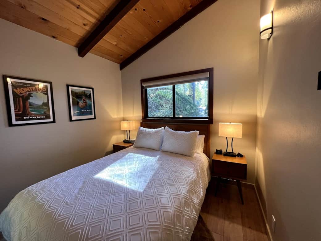 Bedroom 1 with desk and queen size bed on the home's first floor. Room is ideal for guests in your party with difficulty navigating stairs. 