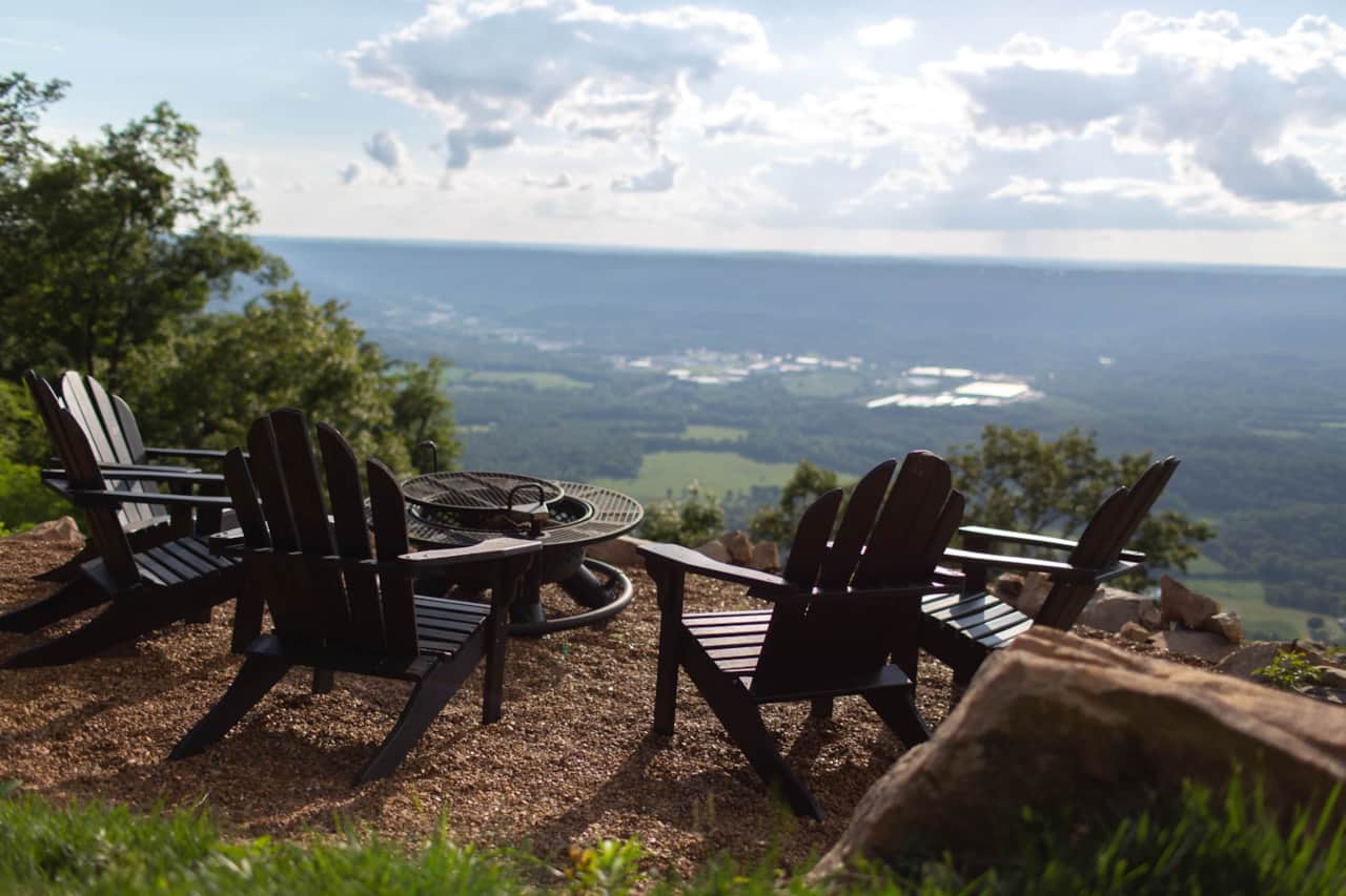 Unwind by the fire as panoramic views stretch across the mountaintops.
