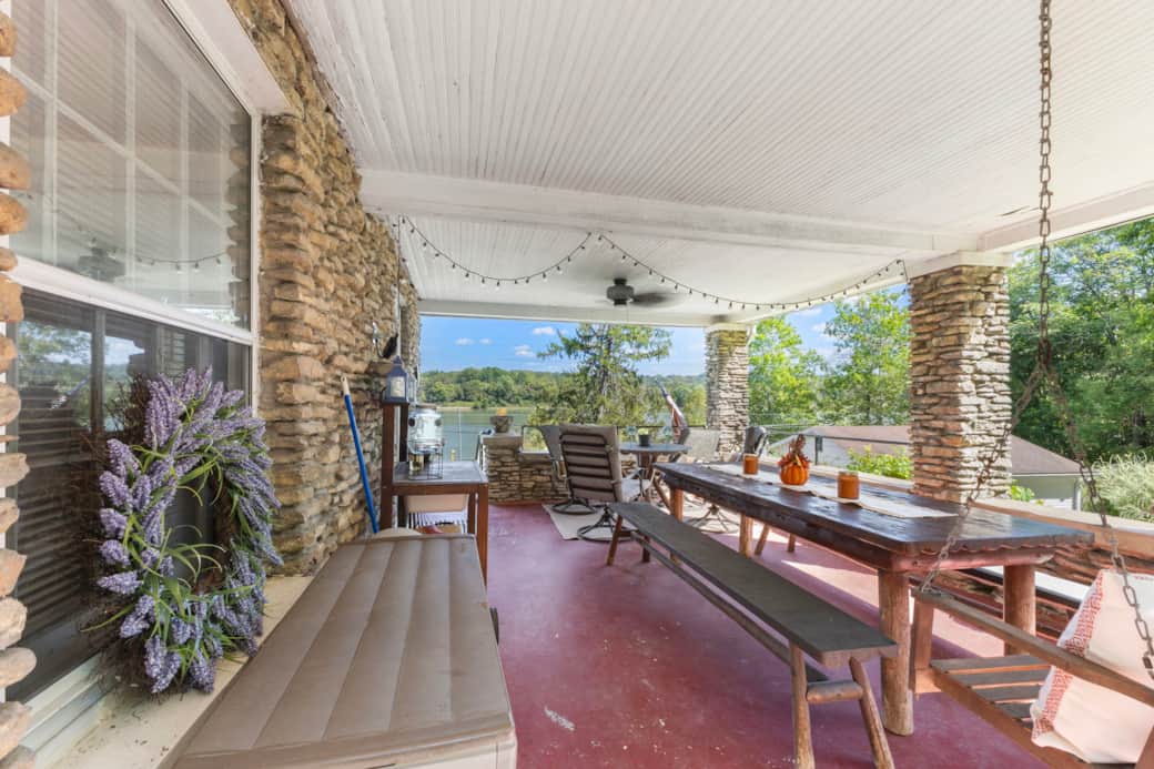 Large covered porch with dining tables for entertaining.