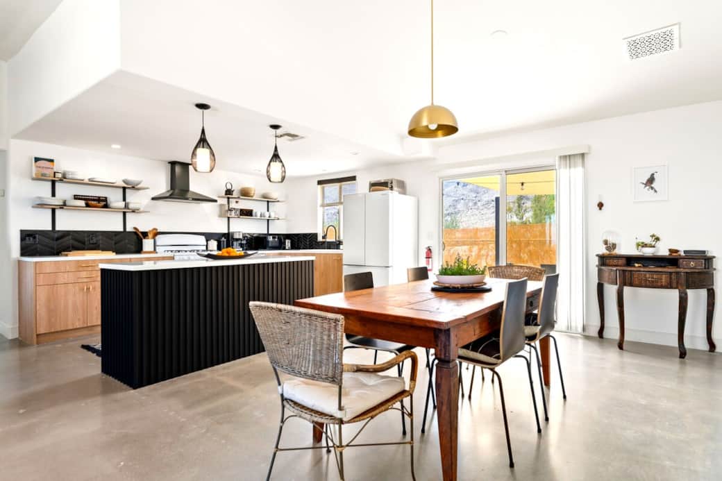 This bright, open kitchen and dining room opens up to the BBQ patio, quail alcove, and expansive views of Joshua Tree National Park,  perfect for gathering indoors and out.