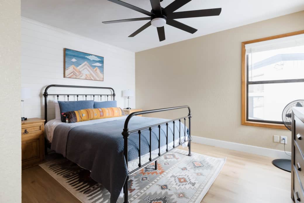 The second bedroom hosts a queen bed, new floors and lots of light.