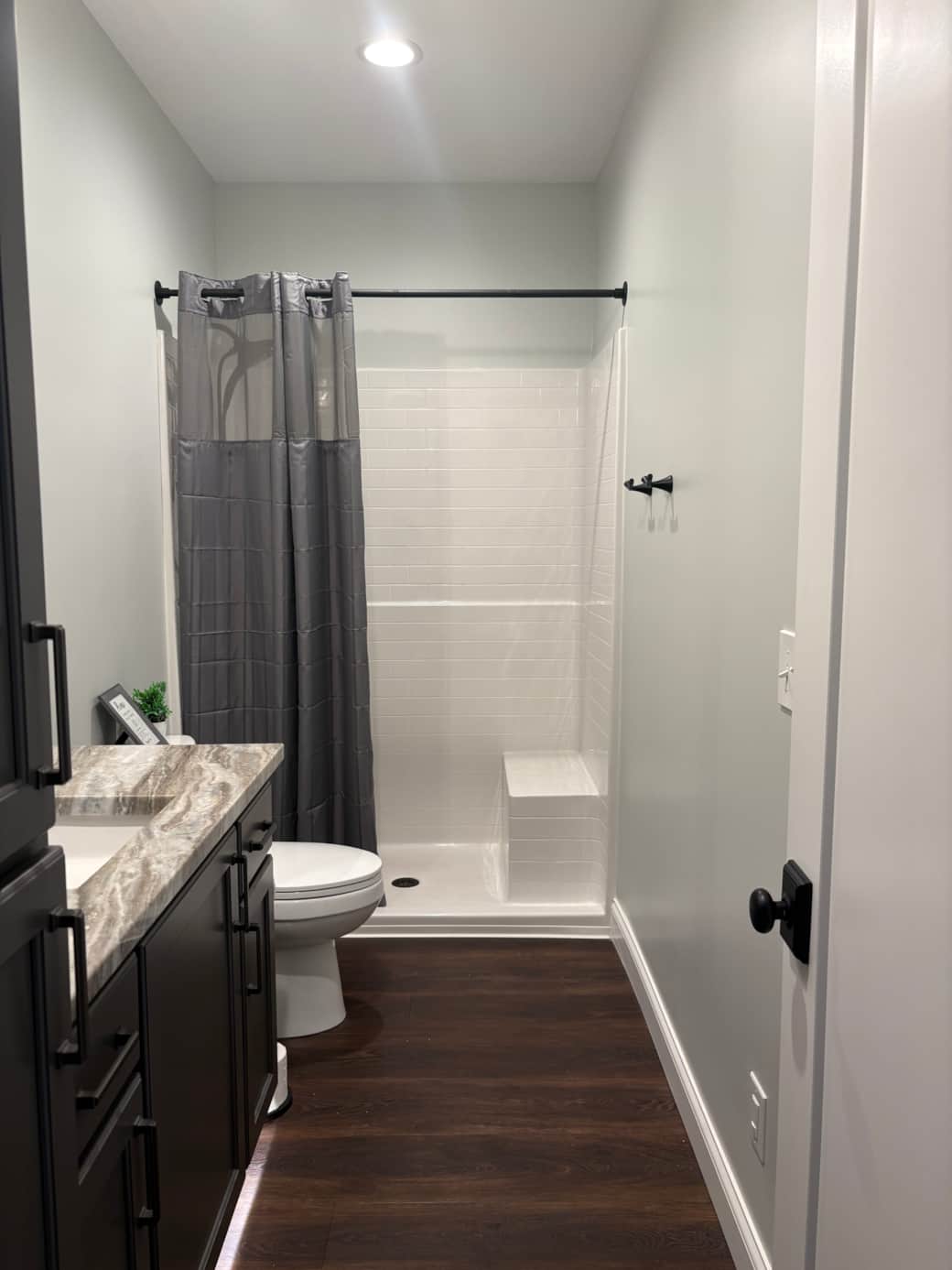 Main level bathroom #2: hand held shower, bench, towel hooks 