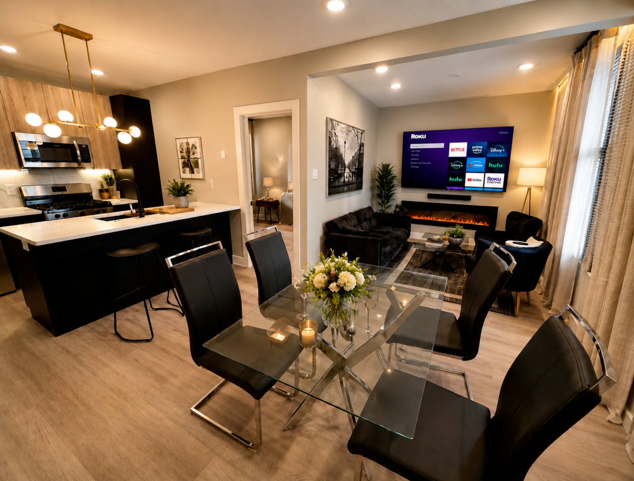 Enjoy this stylish open-concept space featuring a fully equipped kitchen with a quartz island, a dining area for four, and a cozy living room with a fireplace and Roku TV. Perfect for relaxing, entertaining, or enjoying a comfortable stay with all the essentials.
