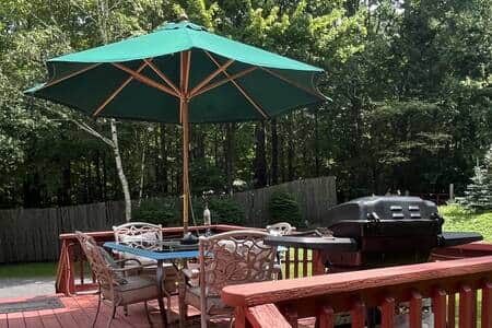Out door eating area with gas BBQ grill.