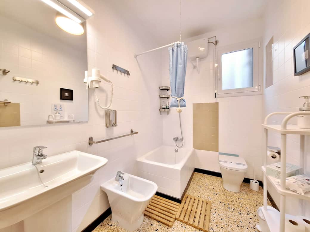 Bathroom with bathtub, toilet, bidet, and sink