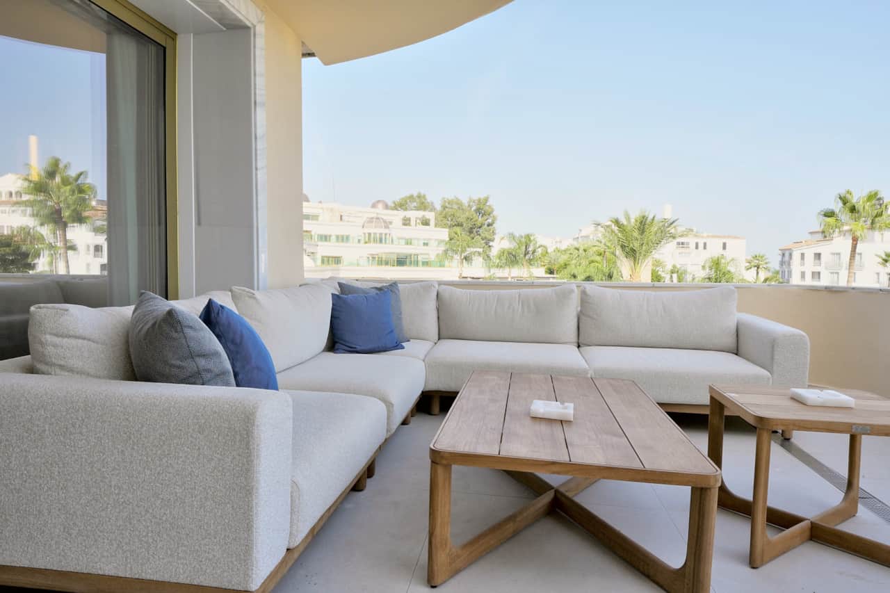 Covered terrace lounge with palm trees