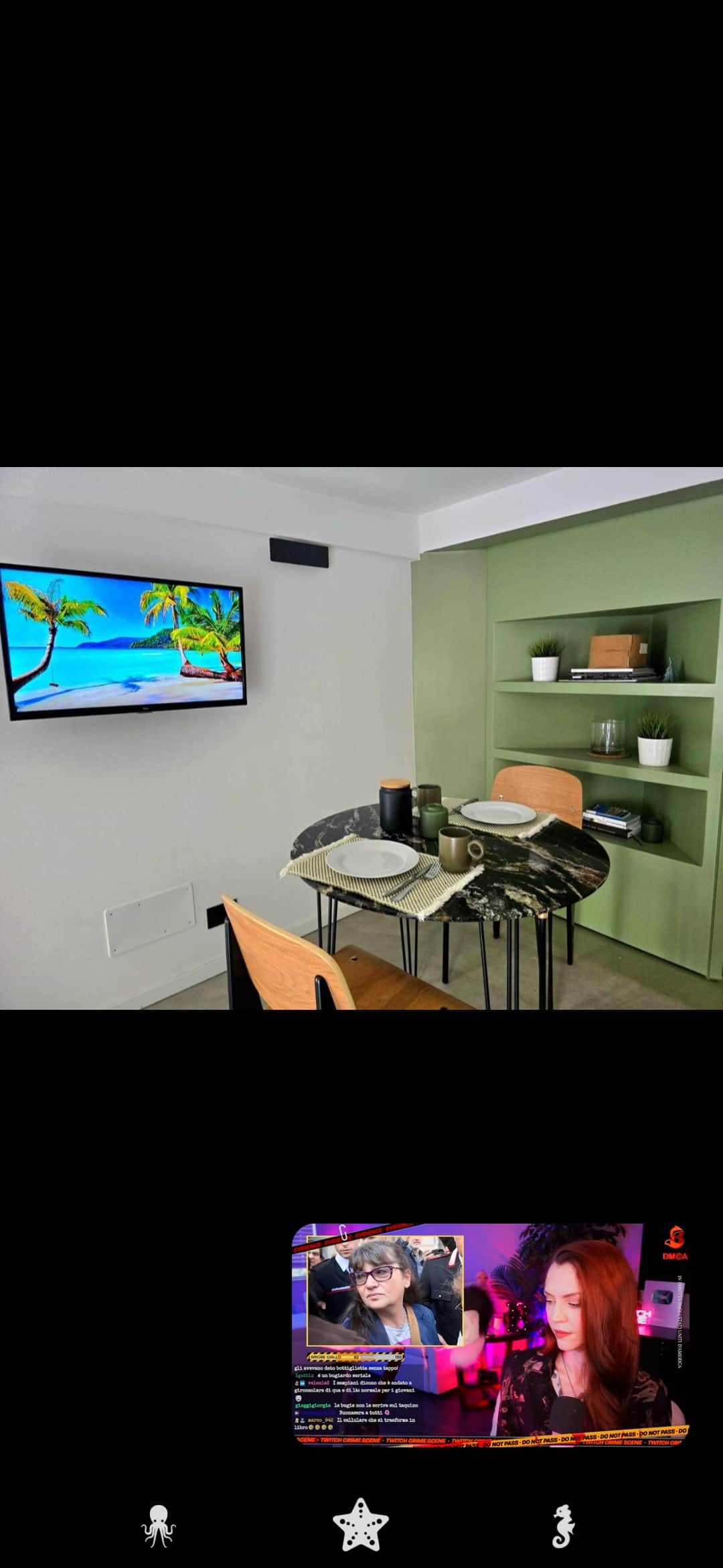 Dining table beside the sage-green kitchenette