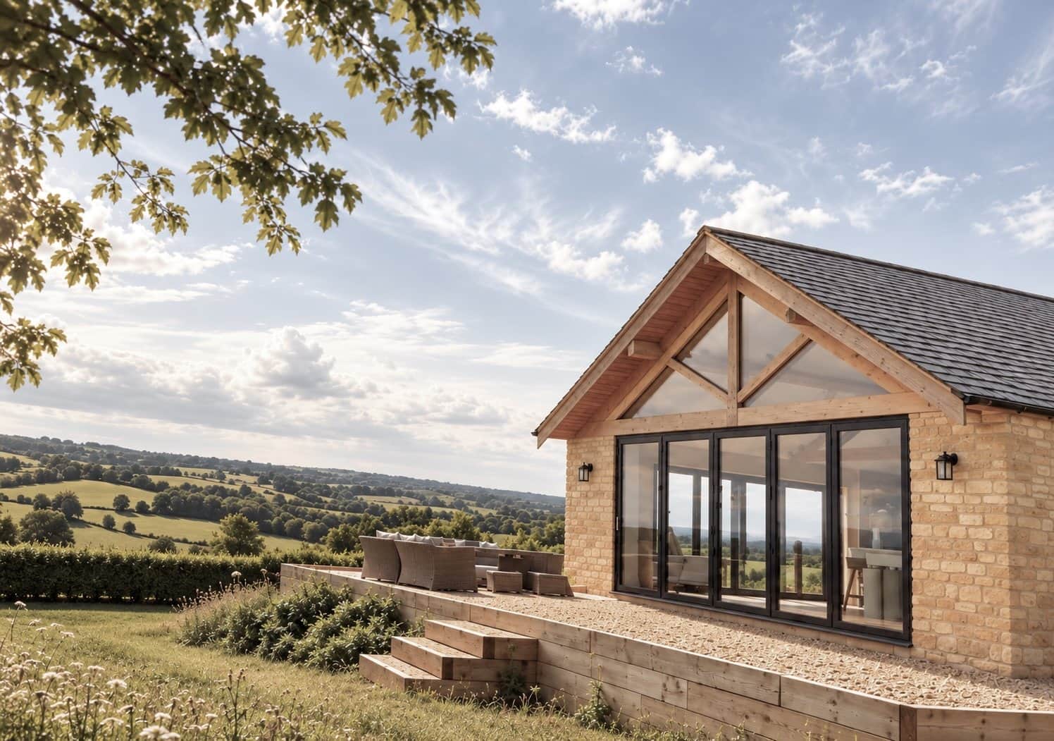 Exterior of The Cotswold Barn surrounded by open countryside