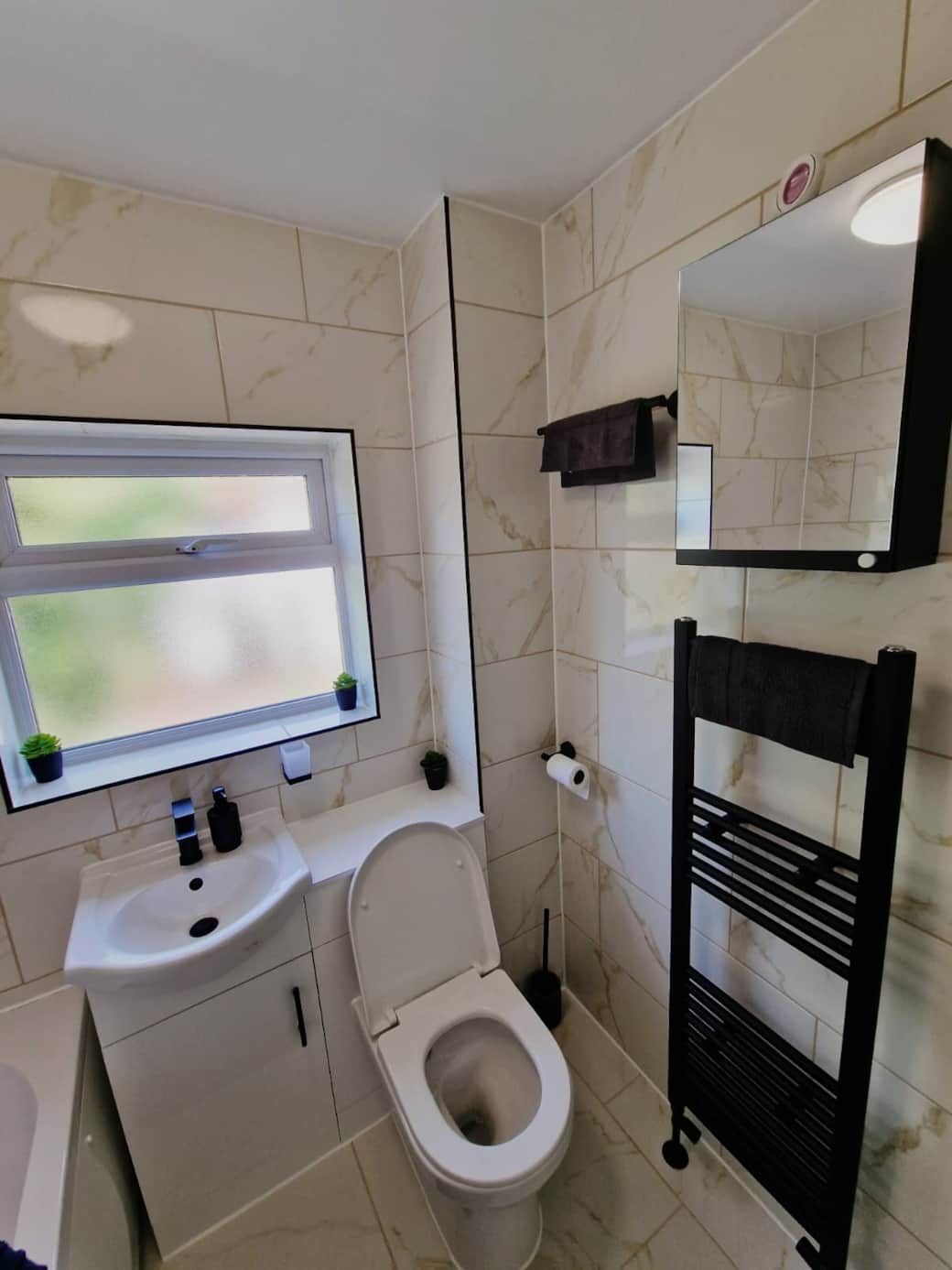 Spacious bathroom with toiletries.