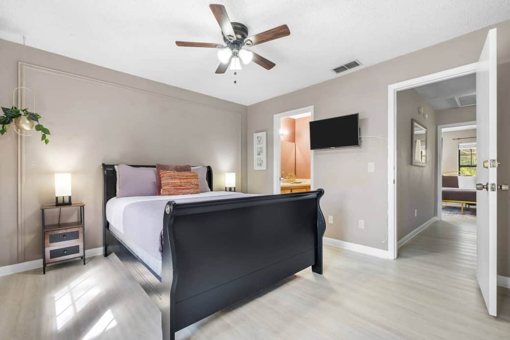 Primary bedroom with queen sized black wood sleigh bed.  This is a solid bed.
