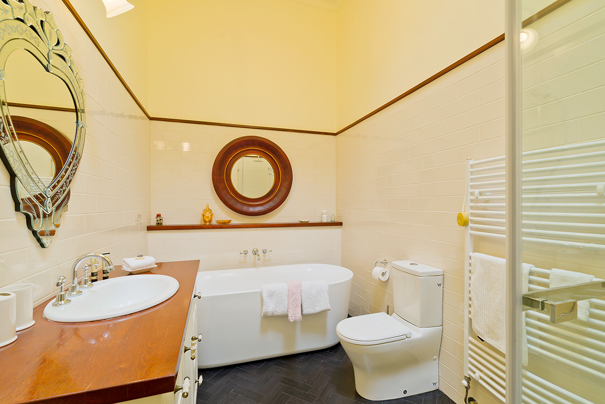 Bathroom with huge bathtub and heating rails for towels 