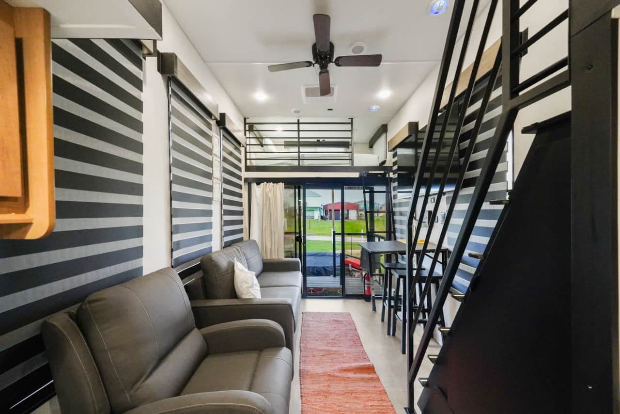 Comfortable sitting area with recliner and loveseat. Loveseat folds into a rv-full bed