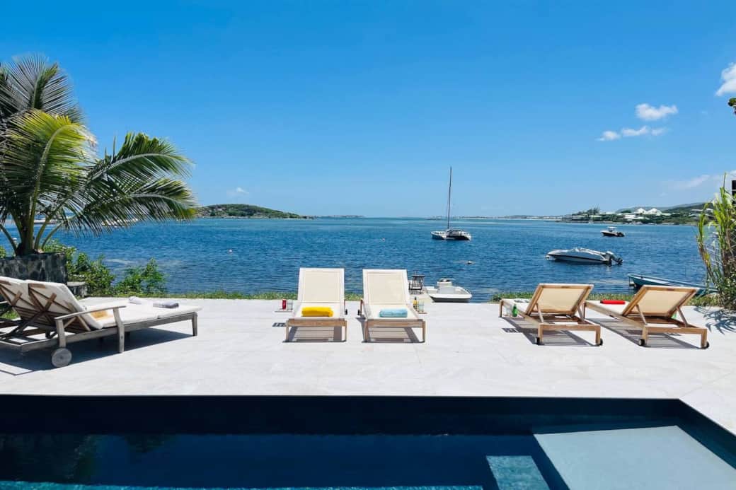 Swimming pool with deck chairs and sea view Chez Martine