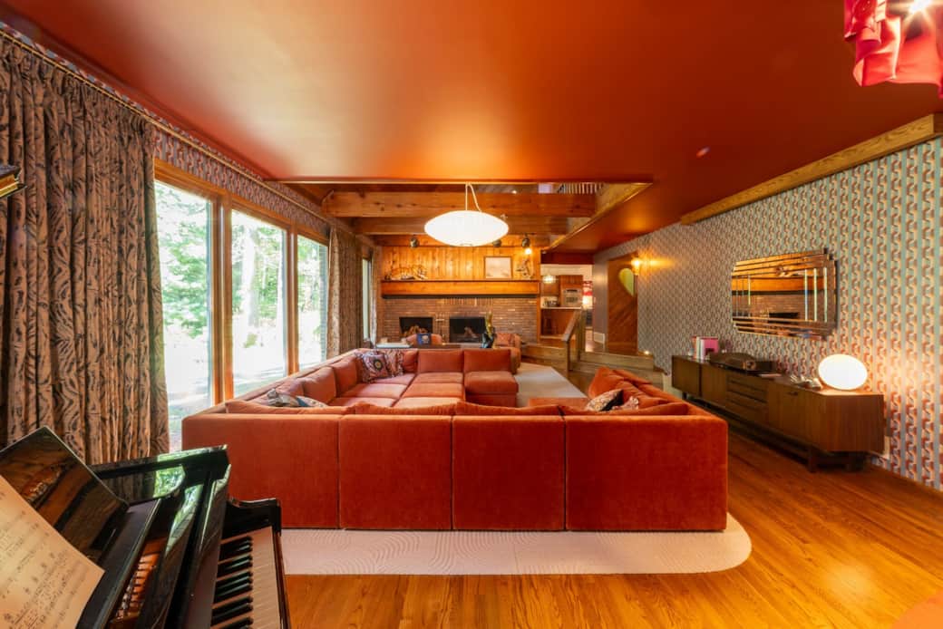 Retro sunken living room with baby grand player piano and 120” home theater Retro sunken living room with baby grand player piano and 120” home theater