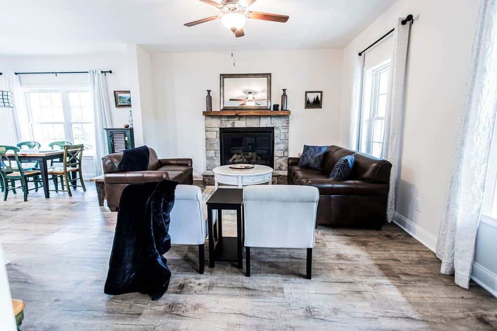 Plenty of seating in and around the living room fireplace. Plus, snuggly blankets.