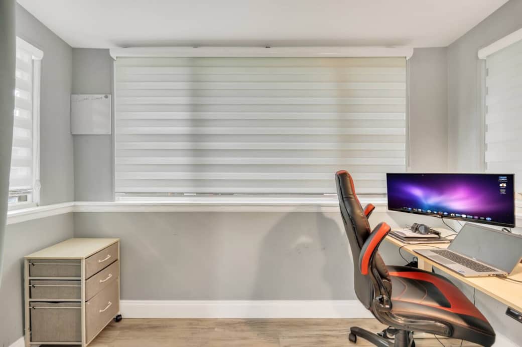 Dual-monitor workstation with a motorized sit-stand desk for flexible comfort while you work.