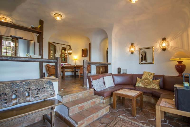 Rocadelmar1 living room with leather sofaset and view of kitchen and indoor dining area