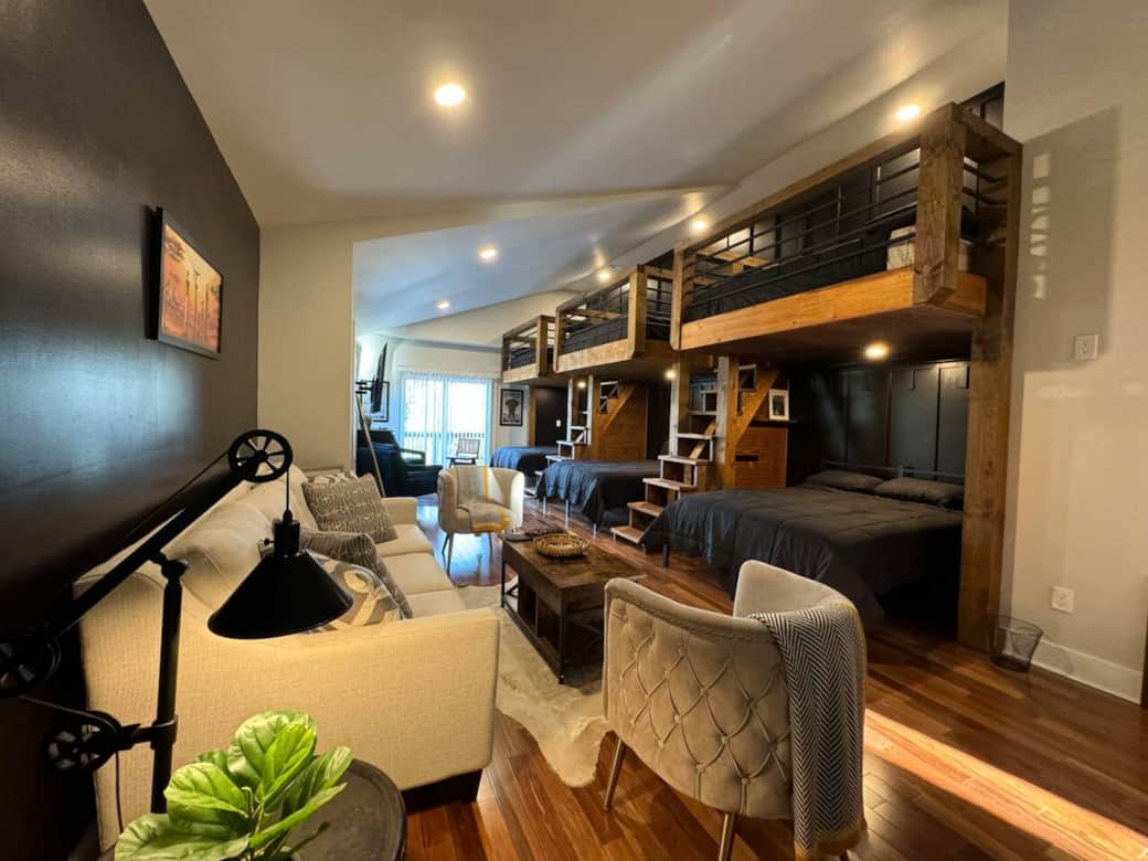 Additional seating with sofas and a table provides space to relax, while the TV and window fill the room with comfort and light.