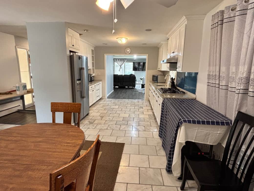 Dining room is adjacent to kitchen which flows into living room. Dining room is adjacent to kitchen which flows into living room.