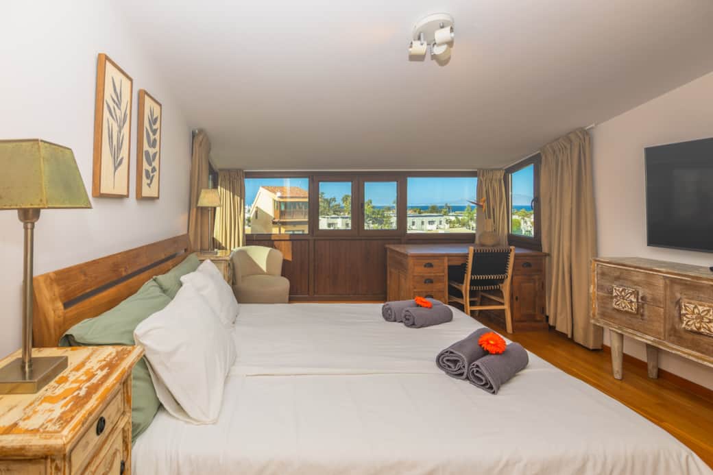 Master bedroom with sea view and en-suite bathroom in your holiday home in Fuerteventura