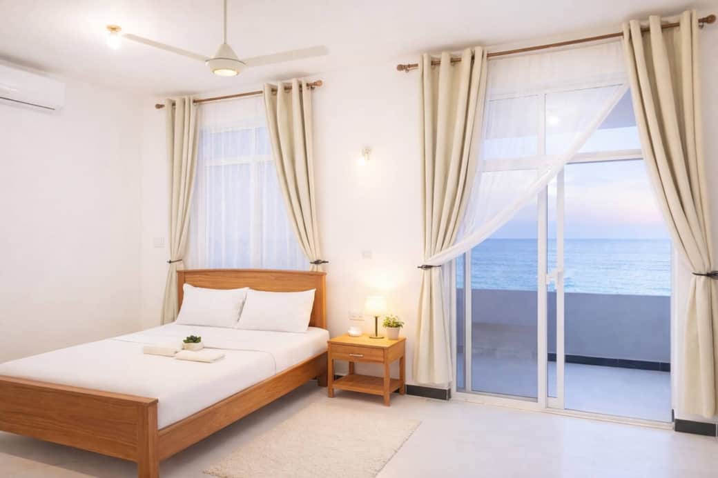 Bright 2BR ensuite room with a comfortable wooden bed, crisp white linens, and soft décor. Includes air-conditioning, large windows, and a private balcony with ocean views. A peaceful, relaxing space filled with natural light and modern comfort. ✨ Bright 2BR ensuite room with a comfortable wooden bed, crisp white linens, and soft décor. Includes air-conditioning, large windows, and a private balcony with ocean views. A peaceful, relaxing space filled with natural light and modern comfort. ✨