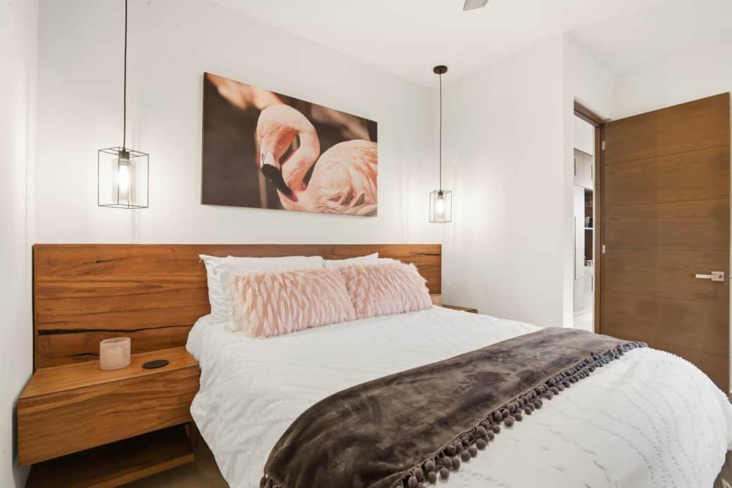 Relax in this cozy bedroom featuring a plush, comfortable bed, warm pendant lighting, and modern décor. The soft pillows and clean, calming design create a peaceful space to unwind and rest. Relax in this cozy bedroom featuring a plush, comfortable bed, warm pendant lighting, and modern décor. The soft pillows and clean, calming design create a peaceful space to unwind and rest.