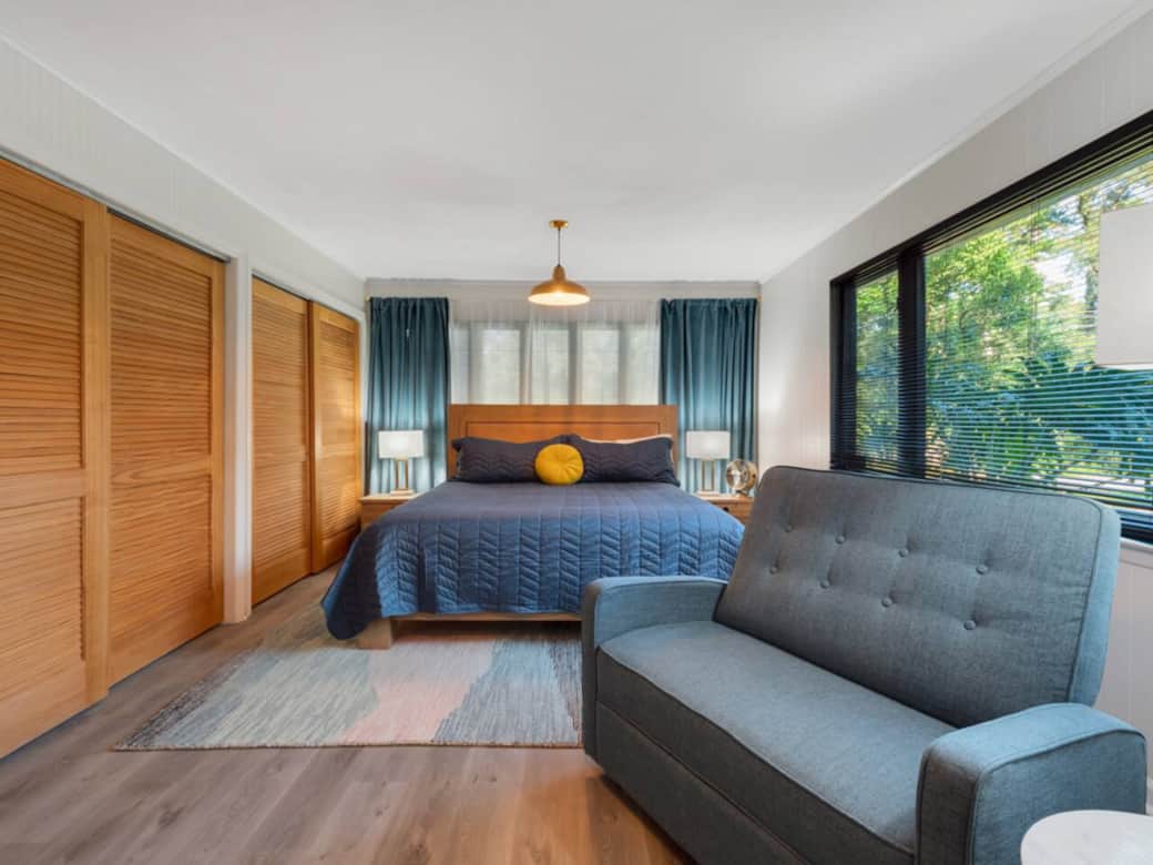 Main bedroom is oversized. King bed with Sterns and Foster mattress and recliner for two! Tons of closet space. Natural light is wonderful.  HVAC controls are behind the bed.
