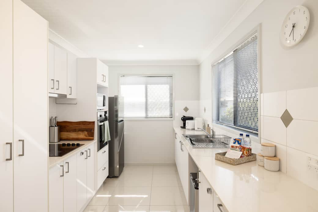 Kitchen: Sleek kitchen with ample storage, modern appliances 