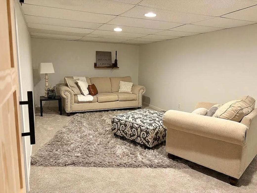 Downstairs living room with comfy couch and oversized chair. Roku Tv in the room but not pictured. Downstairs living room with comfy couch and oversized chair. Roku Tv in the room but not pictured.