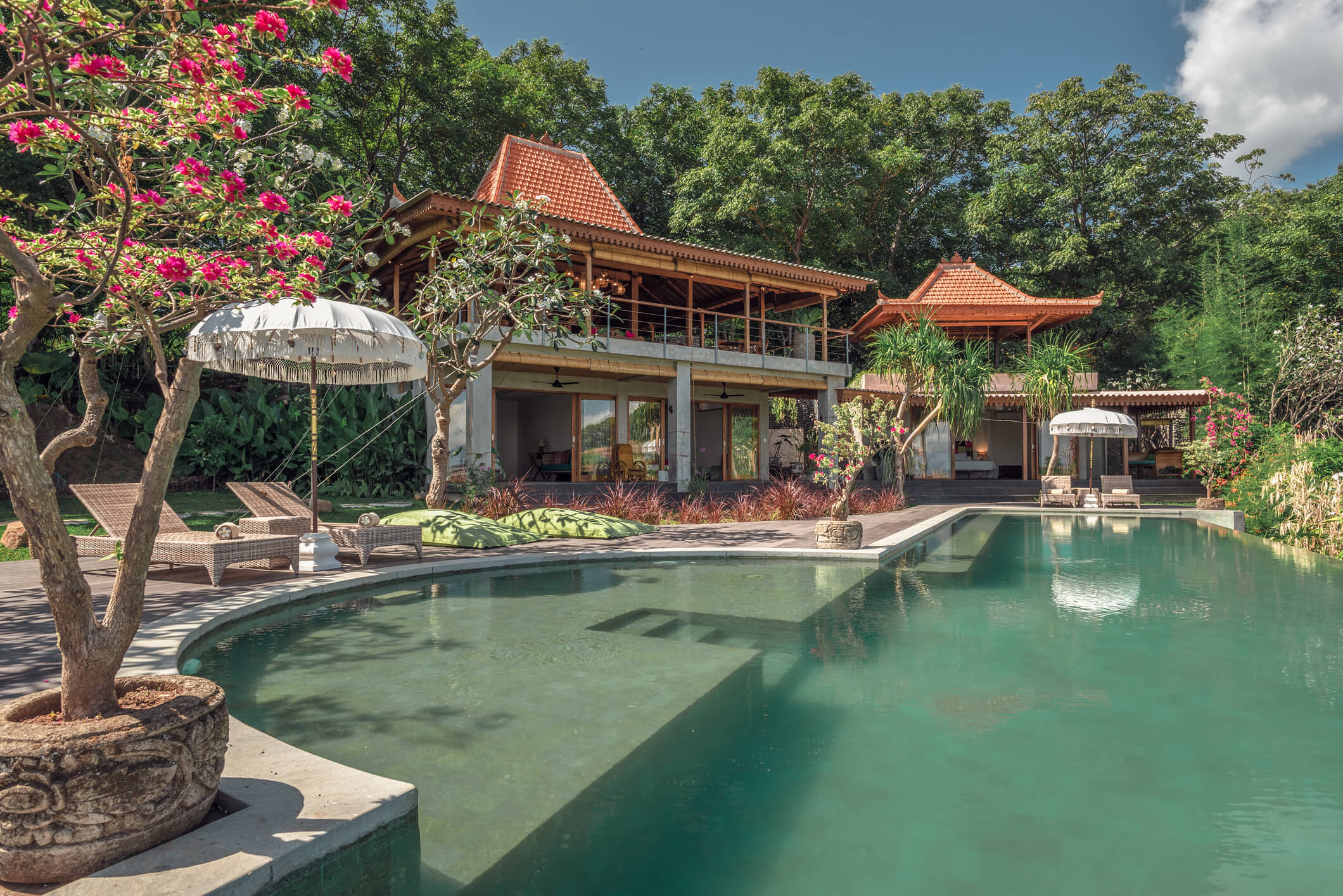 Villa Jamu covered outdoor terrace with bamboo ceiling, wicker furniture, and panoramic mountain views
