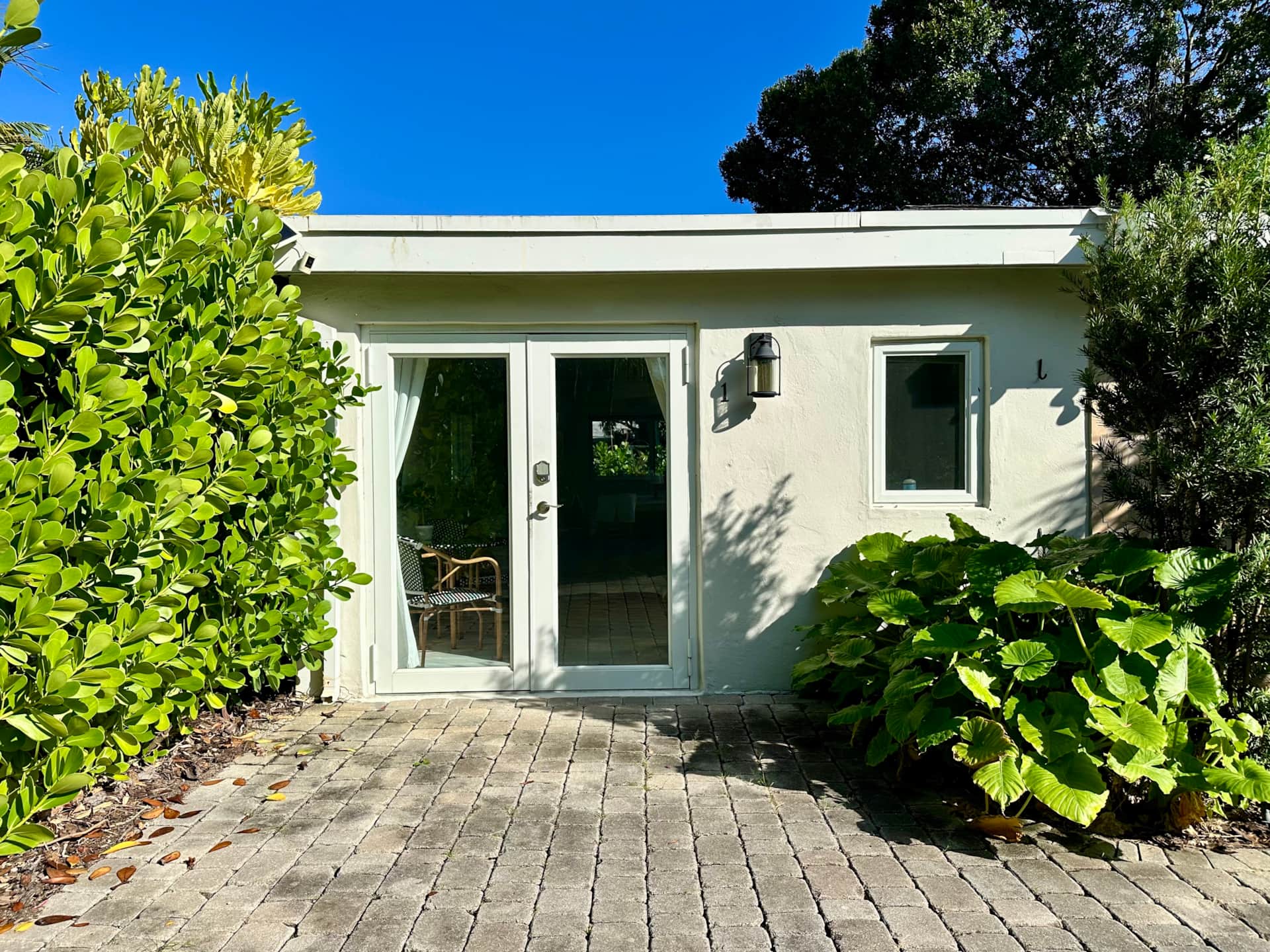 Renovated Unit 1 at Casa Citron featuring a bright interior and double doors opening to the pool deck
