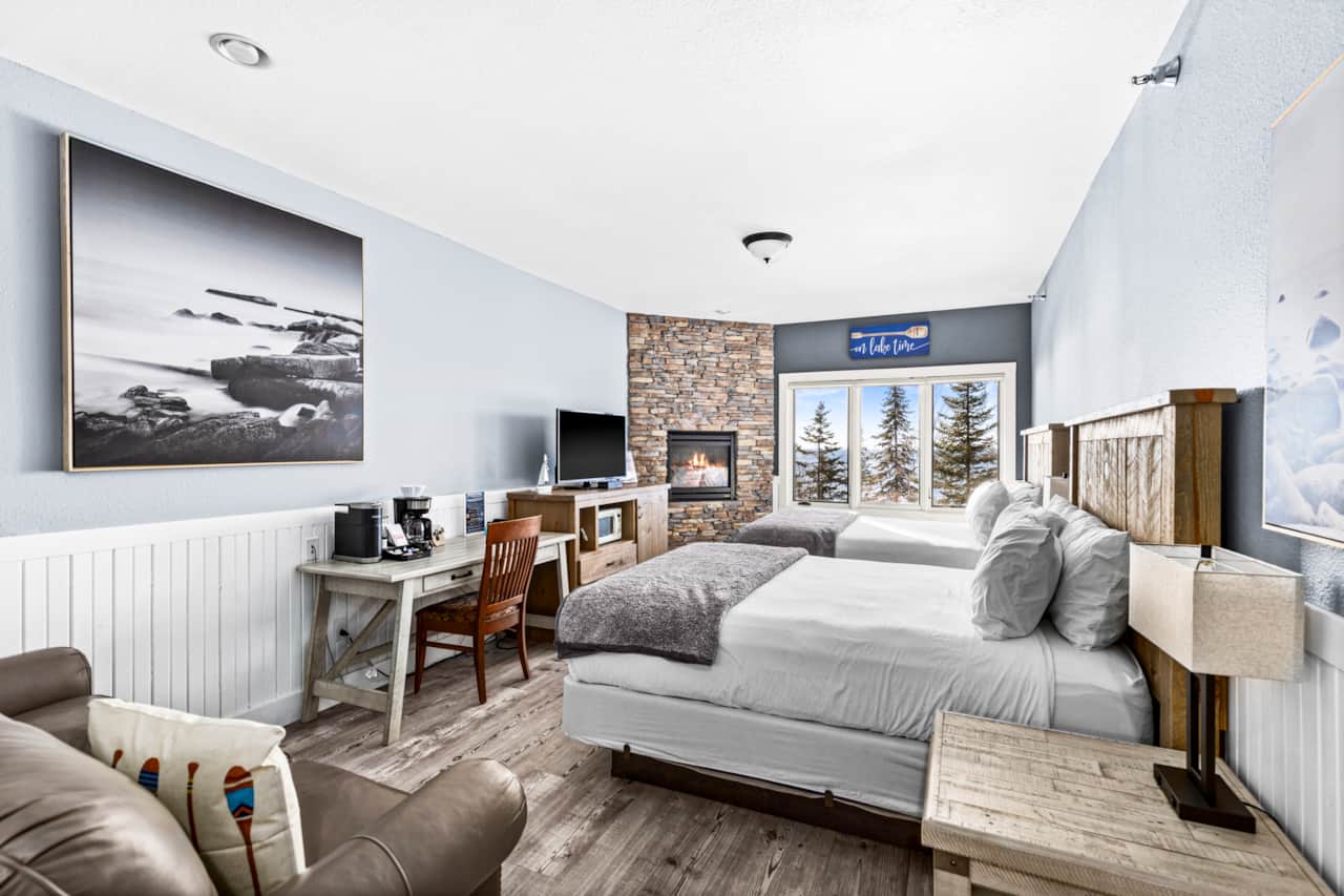 Relax by the fireplace with lake views and two comfy queen beds.