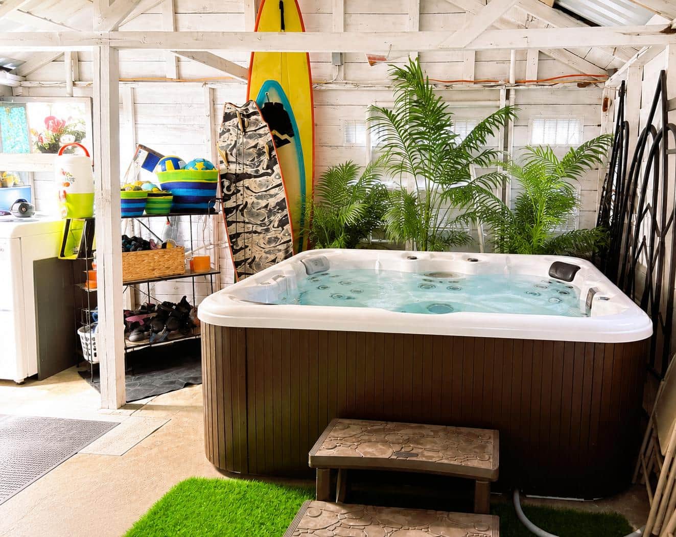 7-person hot tub inside the private garage lounge at White Magnolia Galveston