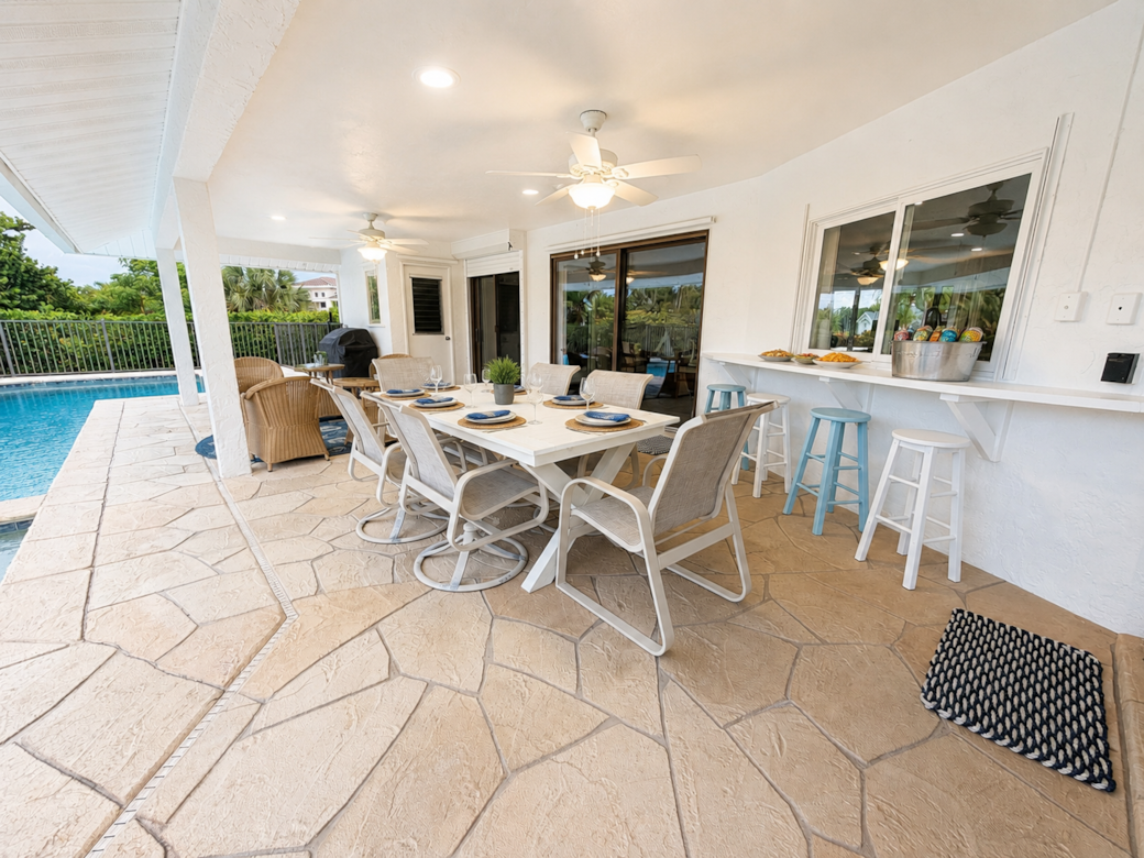 Enjoy meals together in the shade just steps from the pool. Enjoy meals together in the shade just steps from the pool.