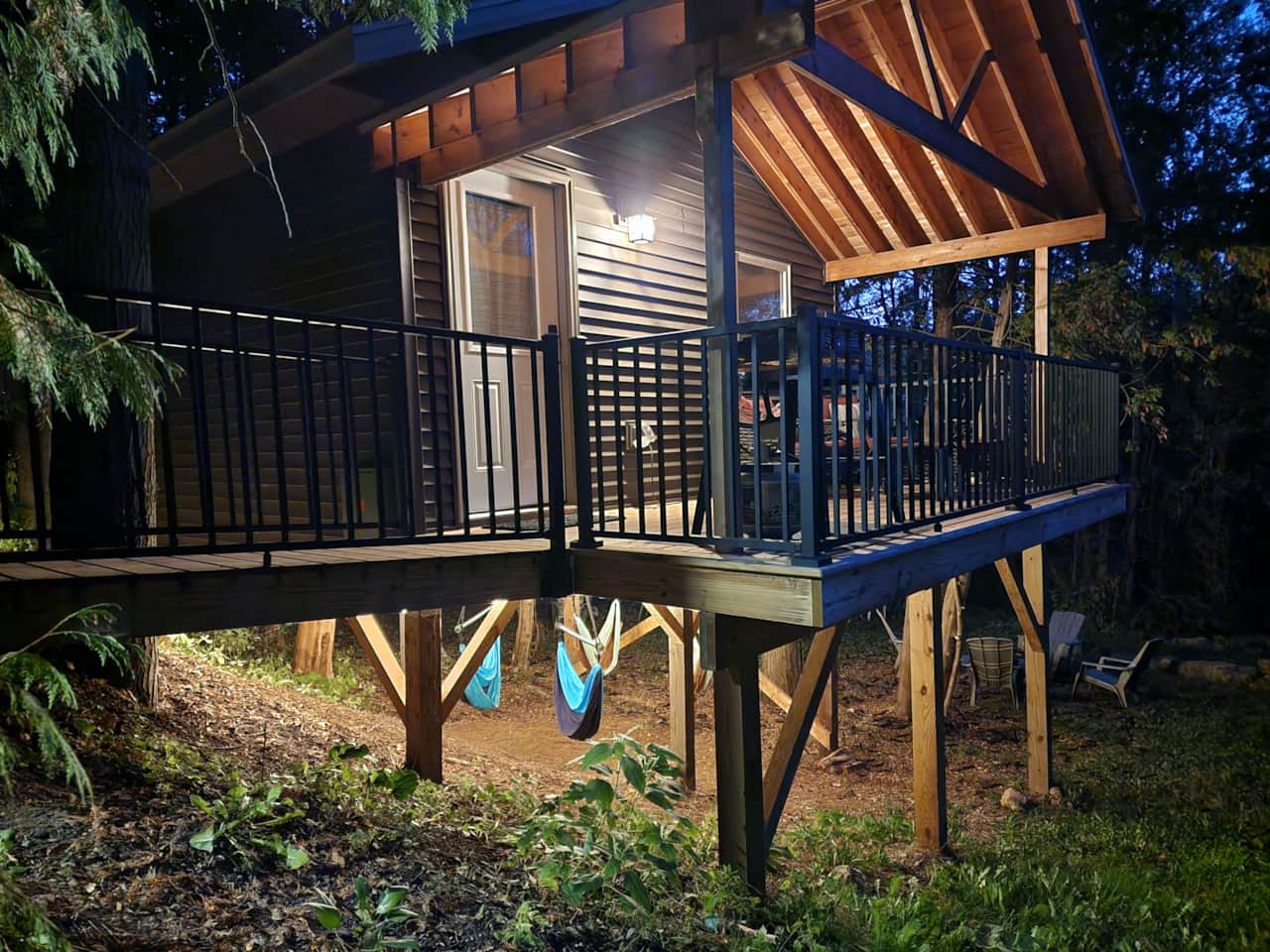 Cabin 3 exterior at night with cafe lights on.