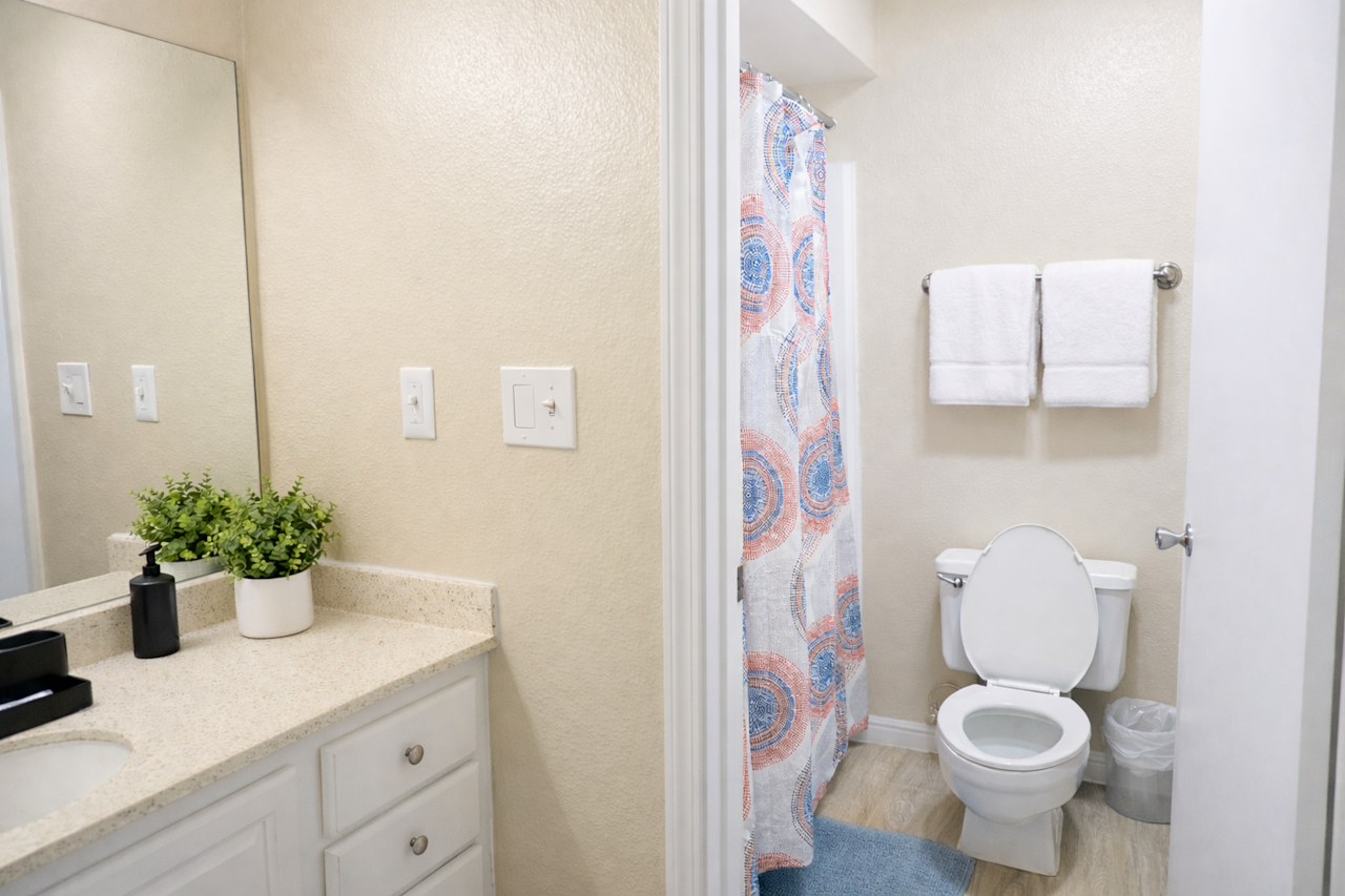 Clean, bright bathroom stocked with essentials for a comfortable stay