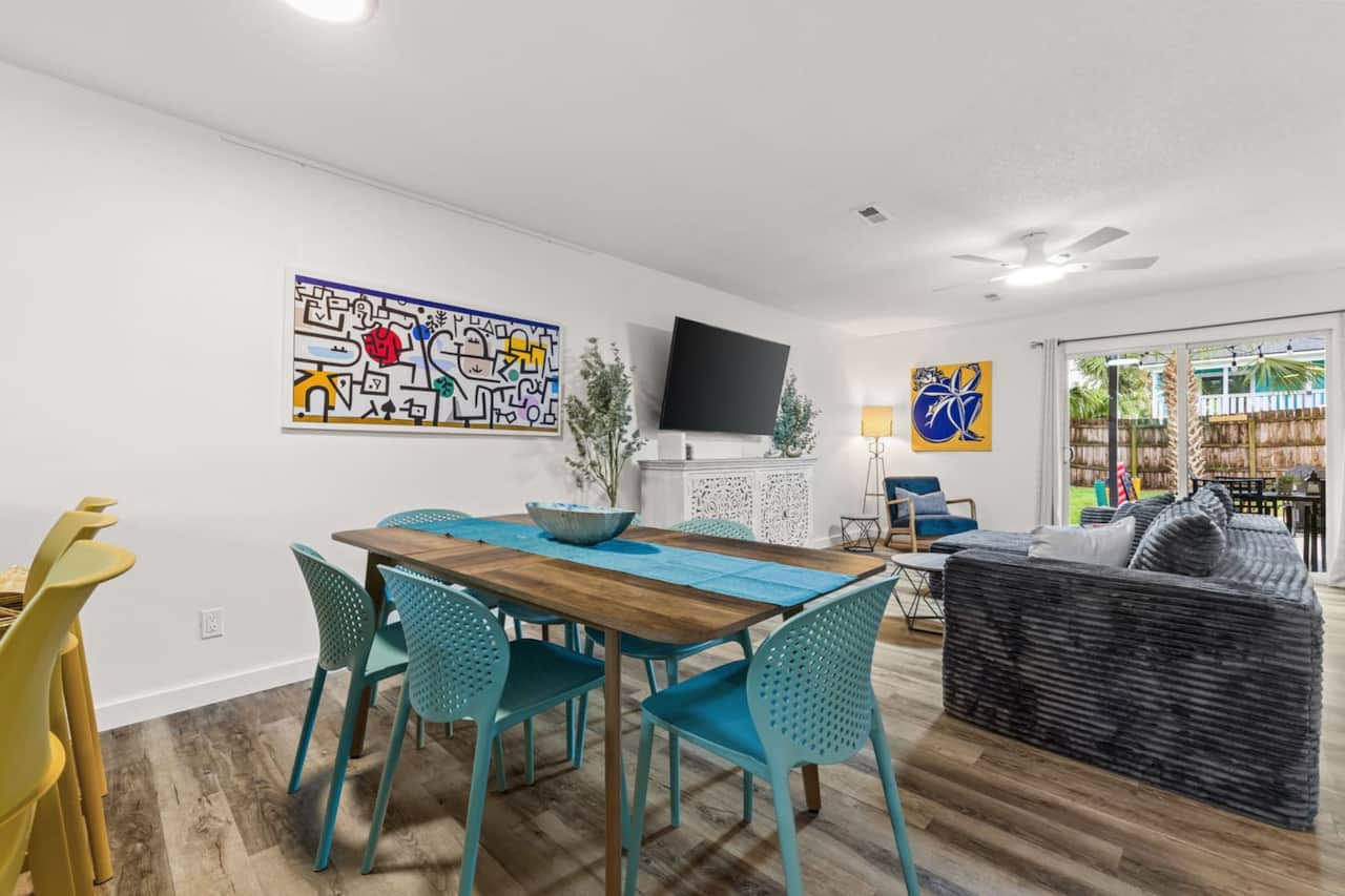 Gather at the dining table with seating for six, plus three stools at the kitchen island. Dinnerware, cutlery, and wine glasses are provided, with a high chair available for little ones. The adjoining lounge has a large smart TV and sectional