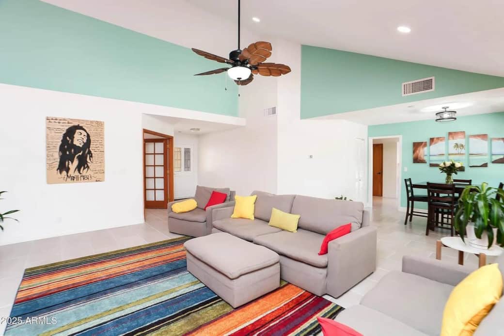 Spacious open-concept living room near Sedona with vaulted ceilings, comfortable seating, and seamless flow into dining and kitchen areas—perfect for groups