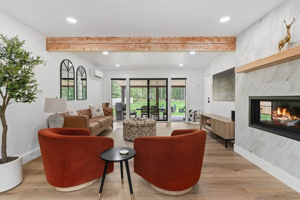 Relax in a cozy living room where you can experience a 65-inch Samsung Frame TV, all set up with Roku for your streaming pleasure. This spacious room features a luxurious linear birch gas log fireplace & direct access to a covered dining area.