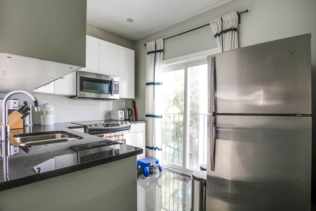 Compact and sleek kitchen in a Toronto cozy apartment, fully equipped for short stays.
