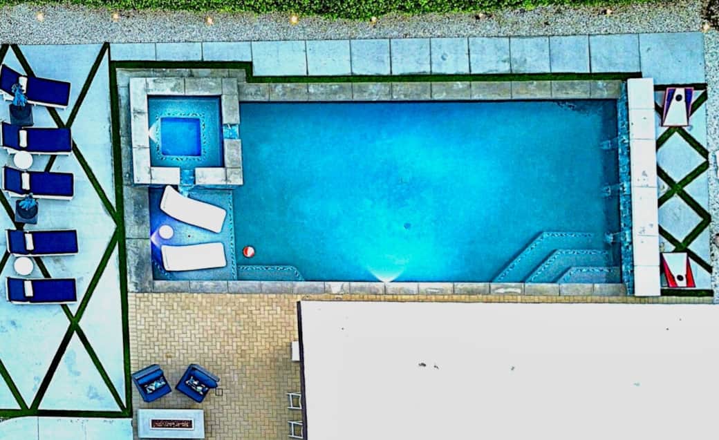 Poolside Paradise: Dive into relaxation with a stunning oasis and stylish lounge chairs! 40' pool has a beautiful sun shelf with loungers and optional in water umbrella.