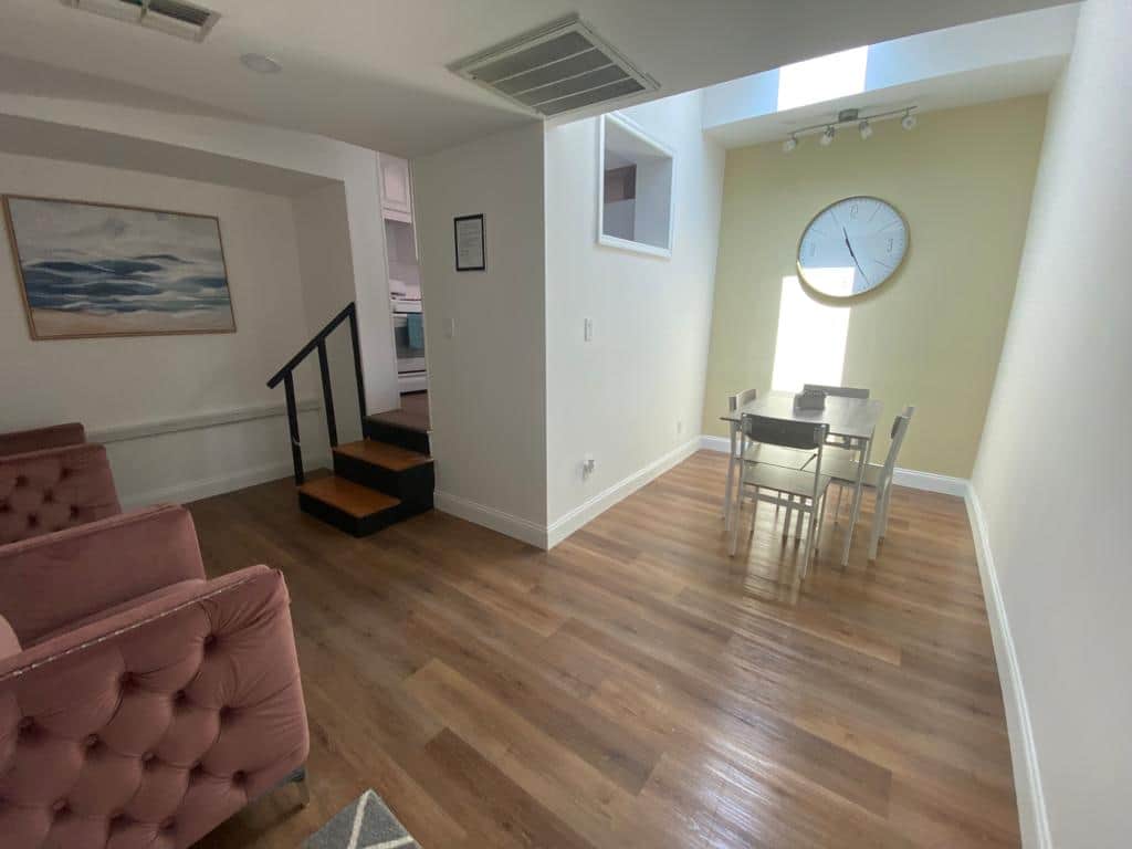 Welcoming living space featuring two armchairs and a dining area for four. Lakeland, FL